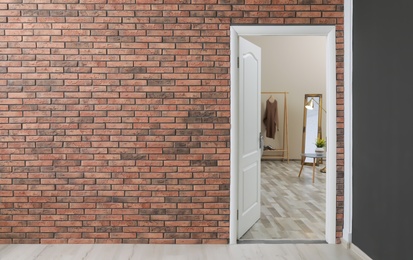 Photo of Stylish room interior, view through open door. Space for text