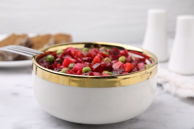 Delicious vinaigrette salad on white marble table, closeup