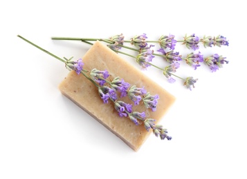 Hand made soap bar with lavender flowers on white background, top view