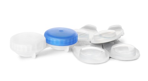 Packages with contact lenses and case on white background