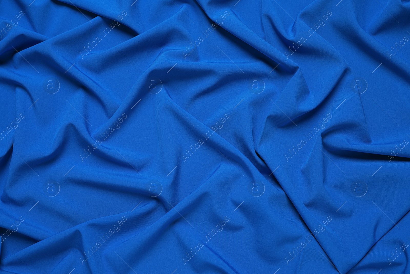 Photo of Crumpled fabric, top view. Color of the year 2020 (Classic blue)