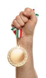 Man holding golden medal on white background, closeup. Space for design