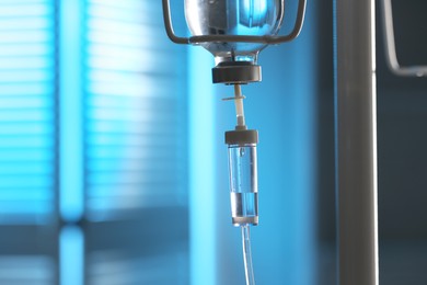 Photo of IV drip against blurred light blue background