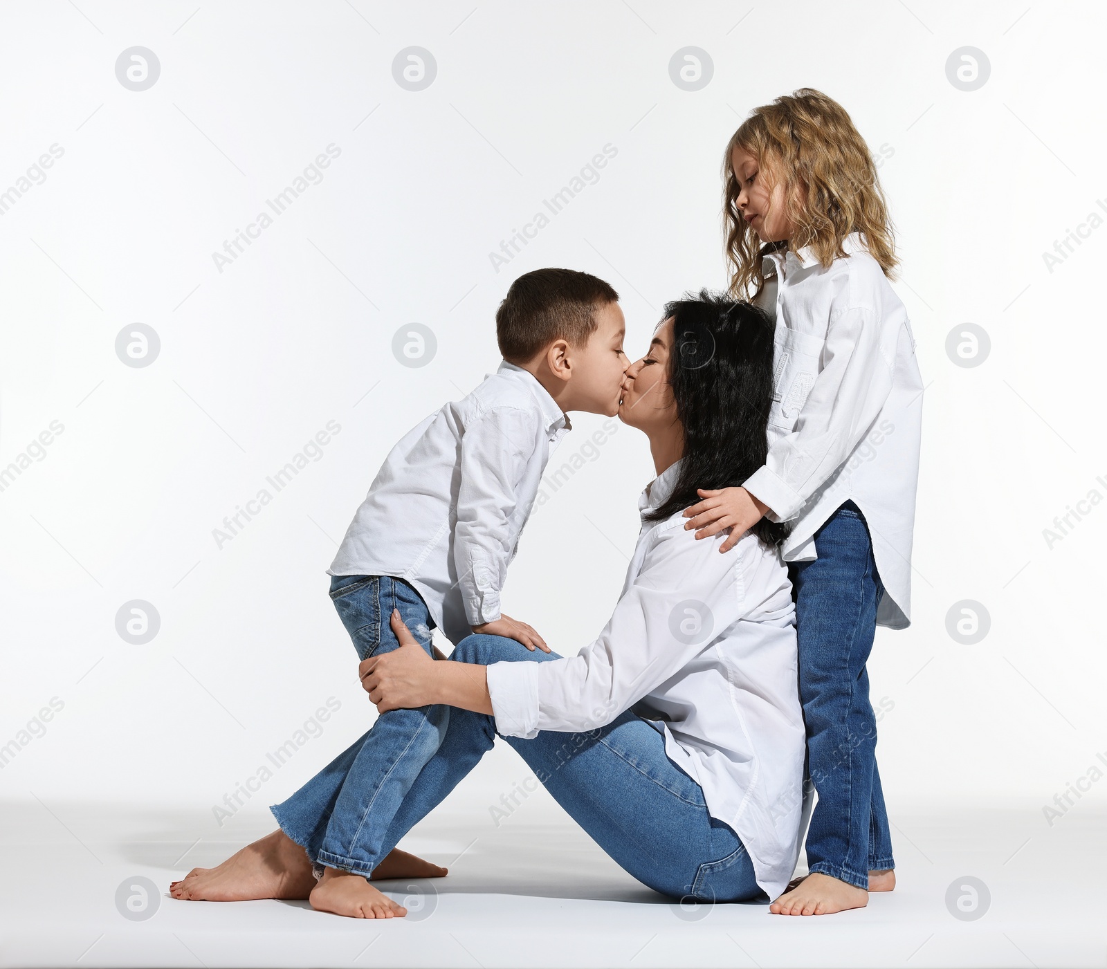 Photo of Little children with their mother on white background