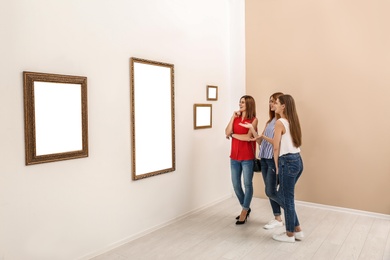 People viewing exposition in modern art gallery