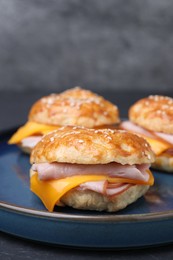 Photo of Delicious bagels with ham and cheese on table, closeup