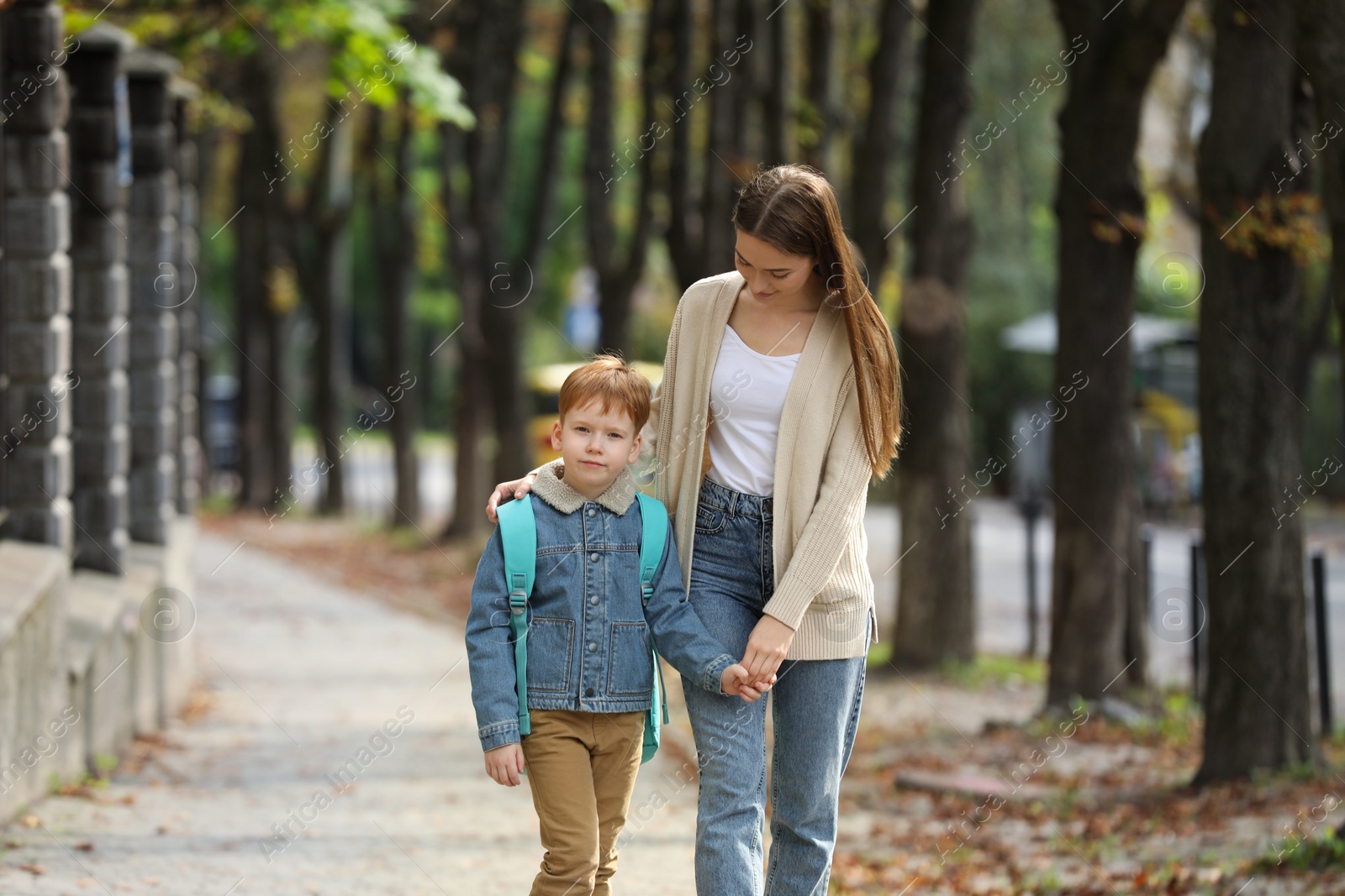 Photo of Young mom taking her son to school