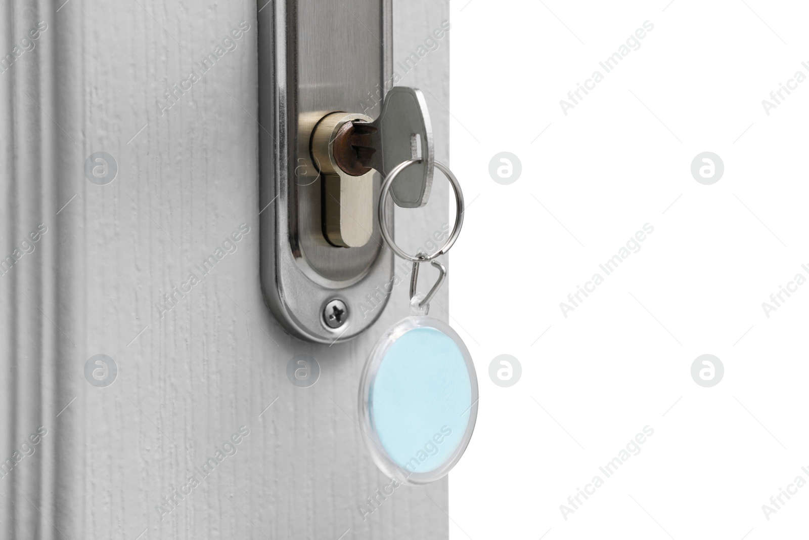 Photo of Key with fob in door lock, closeup. Space for text