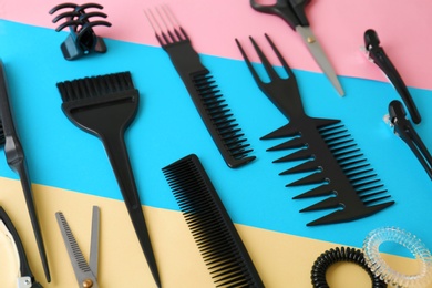 Photo of Professional hairdresser tools on color background
