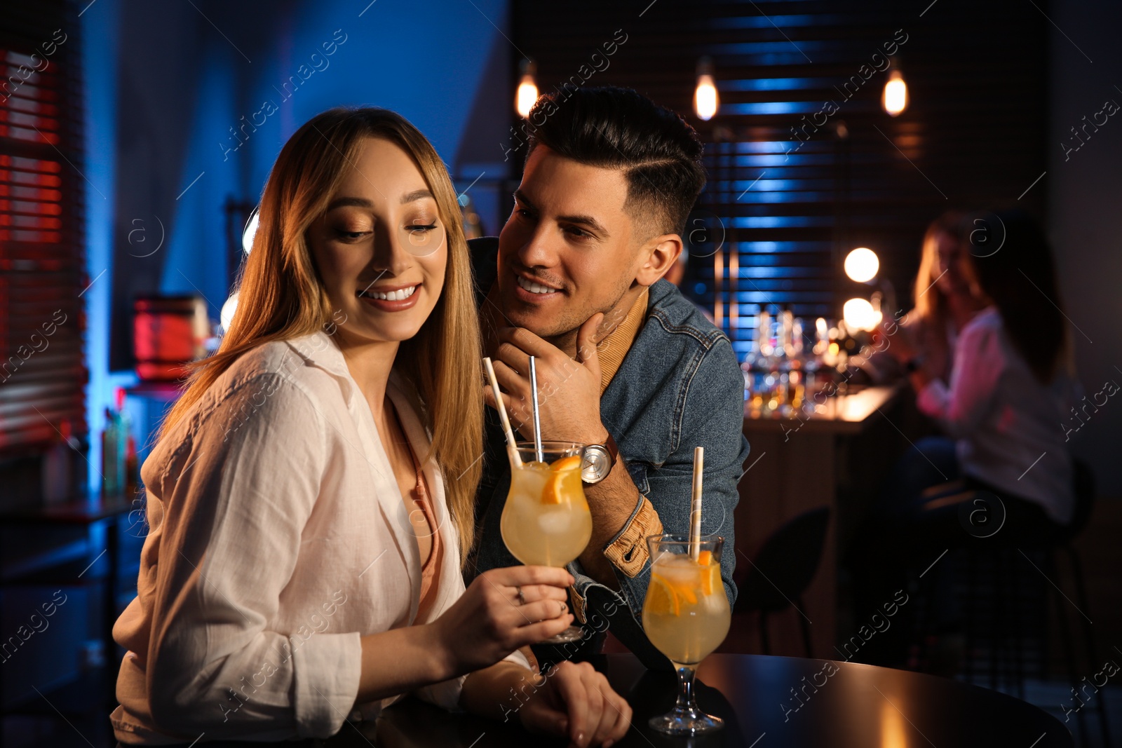 Photo of Man and woman flirting with each other in bar