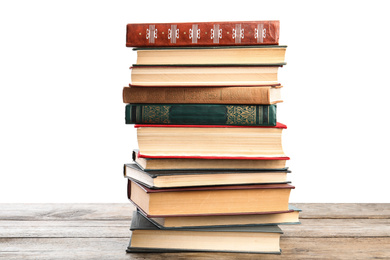 Photo of Stack of old vintage books on wooden table against white background