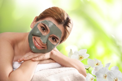 Image of Beautiful woman with mask on face, space for text. Spa treatment