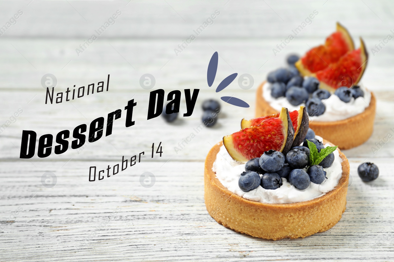 Image of National Dessert Day, October 14. Tasty tartlets with blueberries and figs on white wooden table