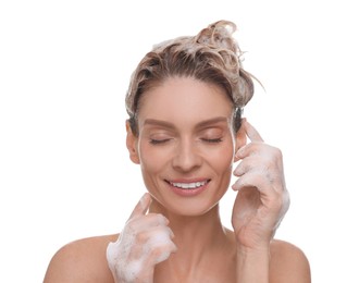 Beautiful happy woman washing hair on white background