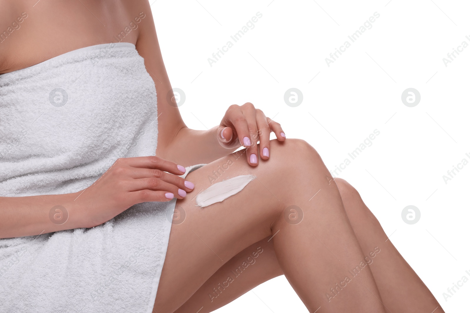 Photo of Woman with smear of body cream on her leg against white background, closeup