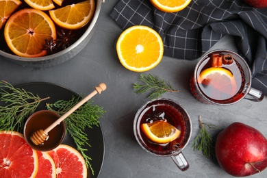 Photo of Flat lay composition with tasty mulled wine on black table