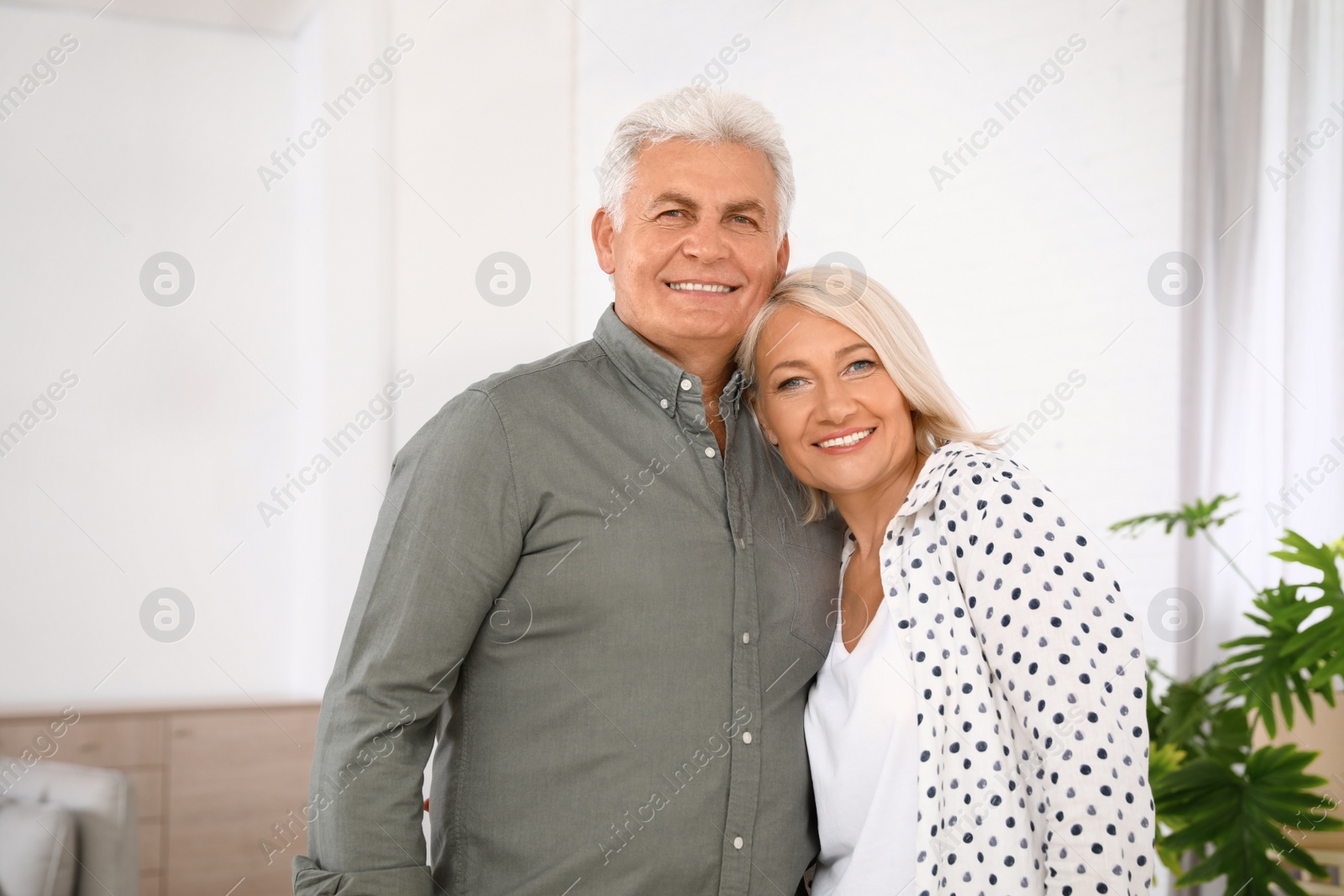 Photo of Portrait of affectionate senior couple at home