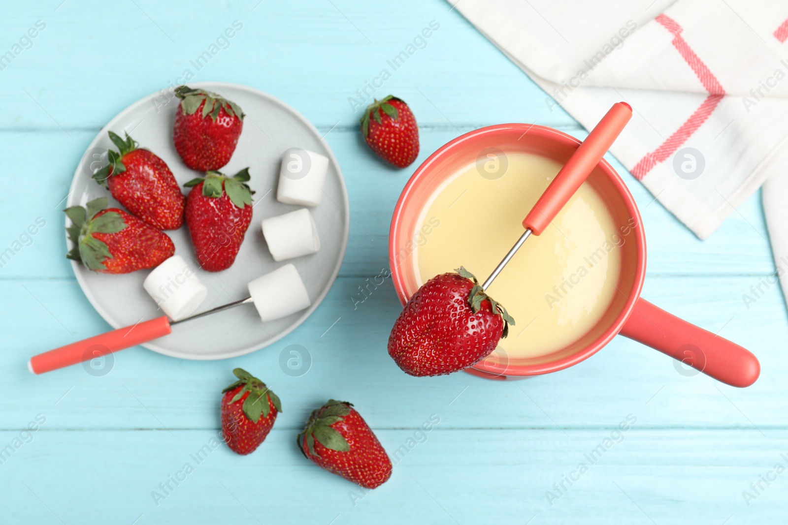 Photo of Chocolate fondue with strawberries and marshmallow on wooden table, flat lay