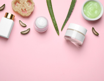 Photo of Flat lay composition with aloe vera and cosmetic products on pink background. Space for text