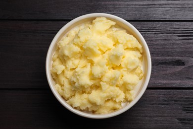 Bowl of Ghee butter on wooden table, top view