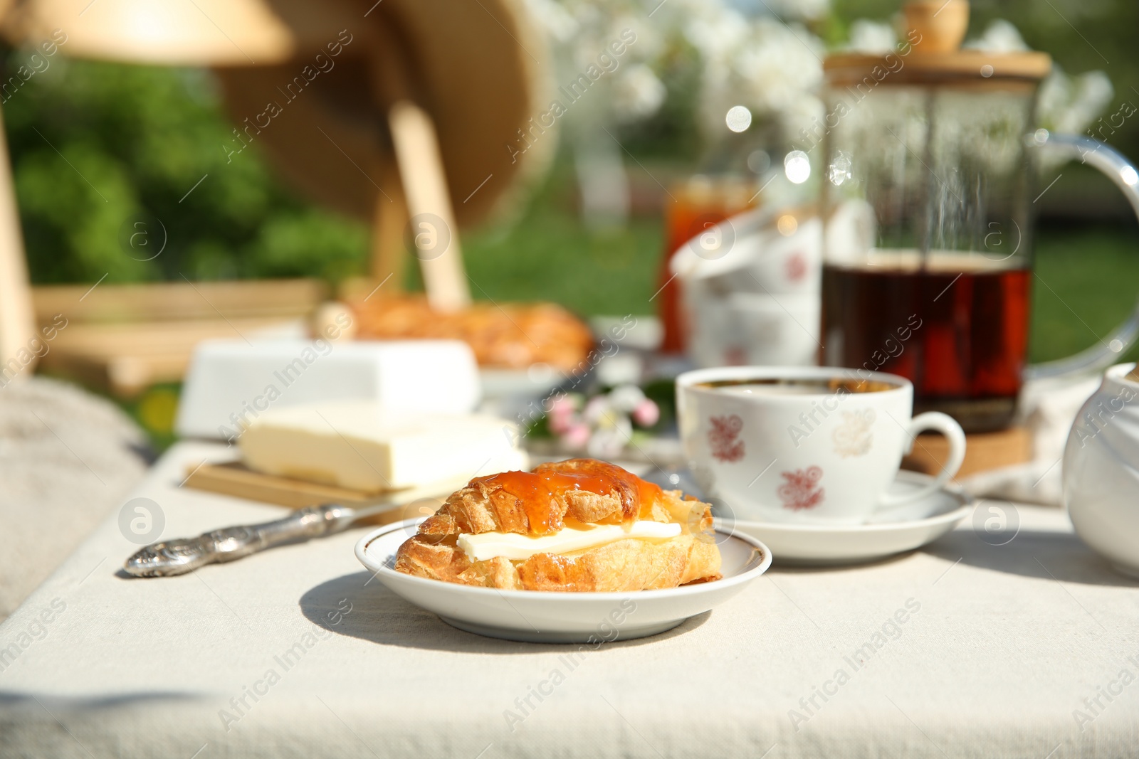 Photo of Beautiful table setting in garden on sunny day