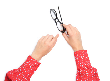 Photo of Woman holding eyeglasses on white background, top view
