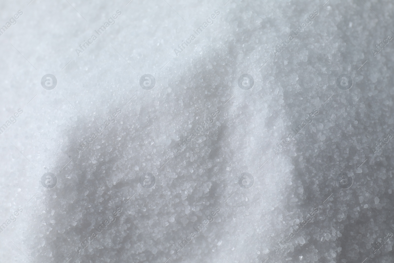 Photo of Organic white sea salt as background, above view