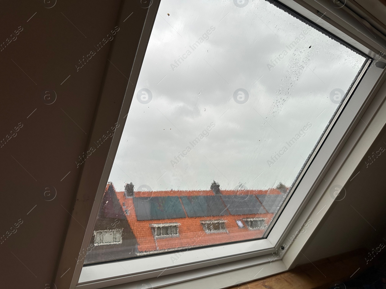 Photo of Window with water droplets on rainy day, closeup