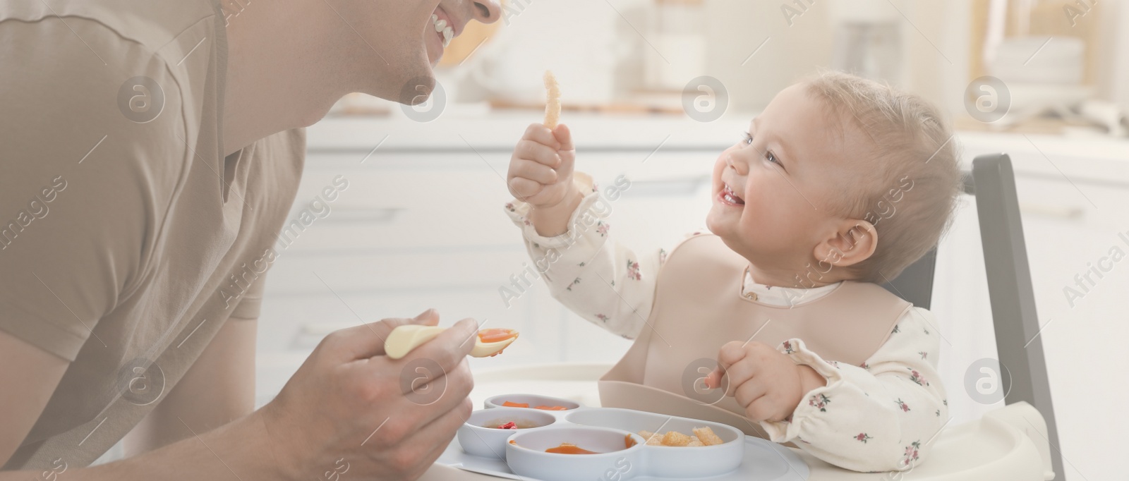 Image of Father feeding his cute little baby healthy food at home. Banner design