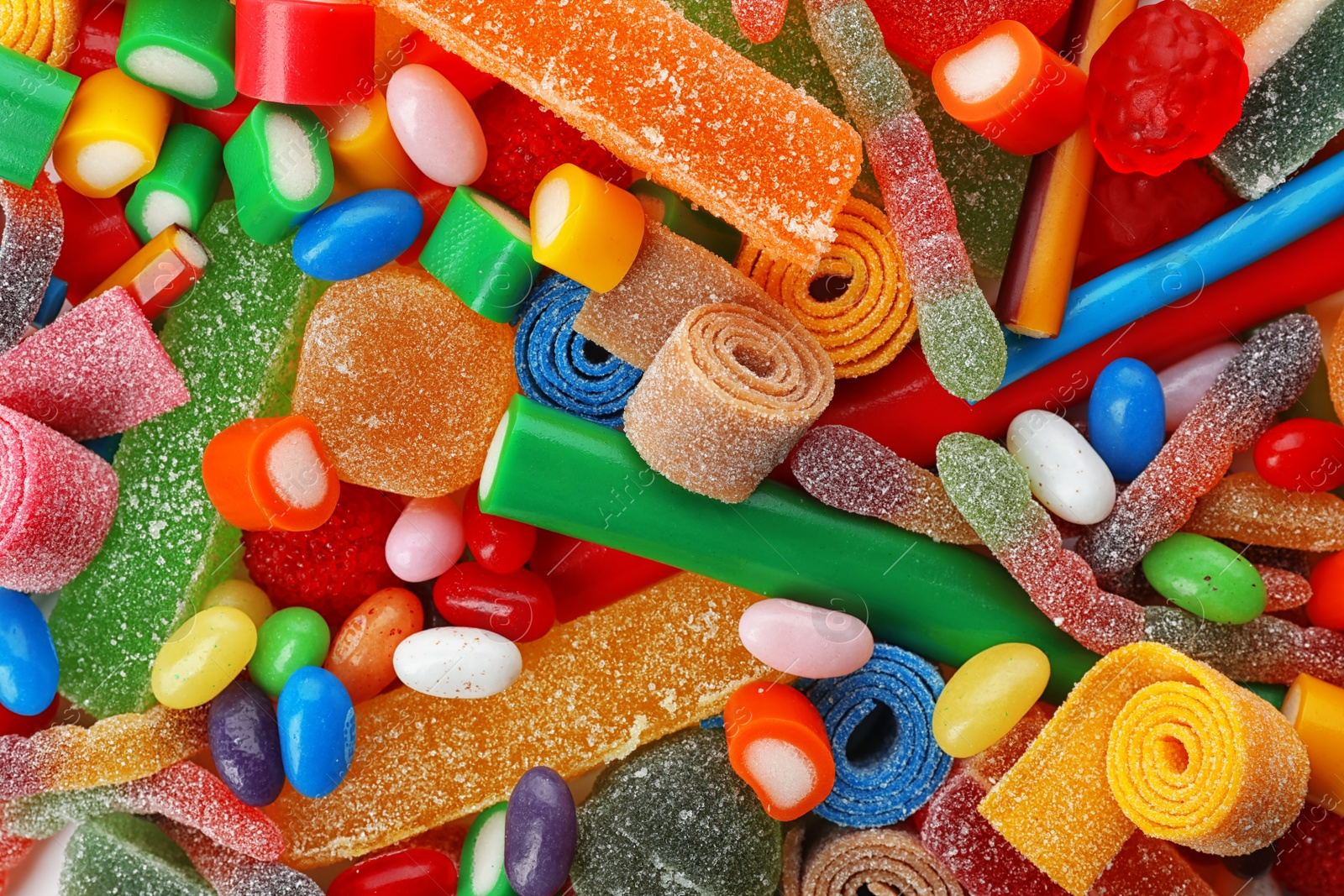 Photo of Pile of delicious colorful chewing candies as background