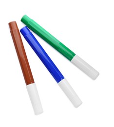 Different colorful markers on white background, top view
