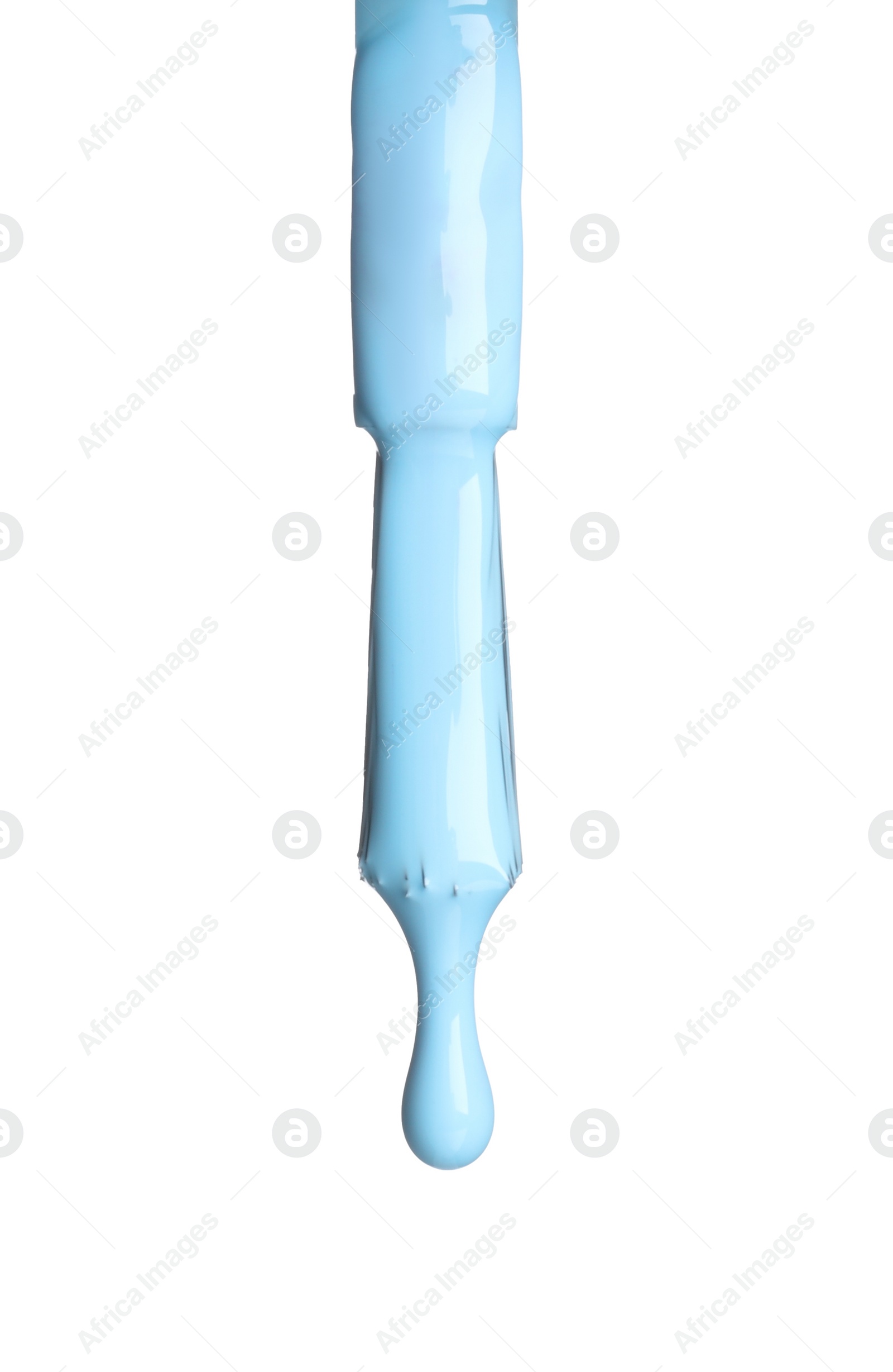 Photo of Light blue nail polish dripping from brush isolated on white