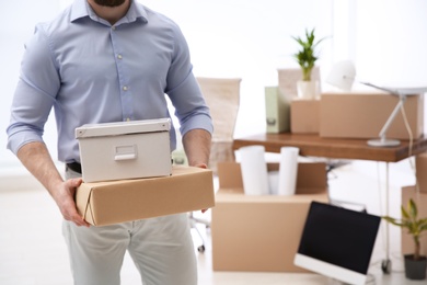 Photo of Man holding moving boxes in new office, closeup. Space for text