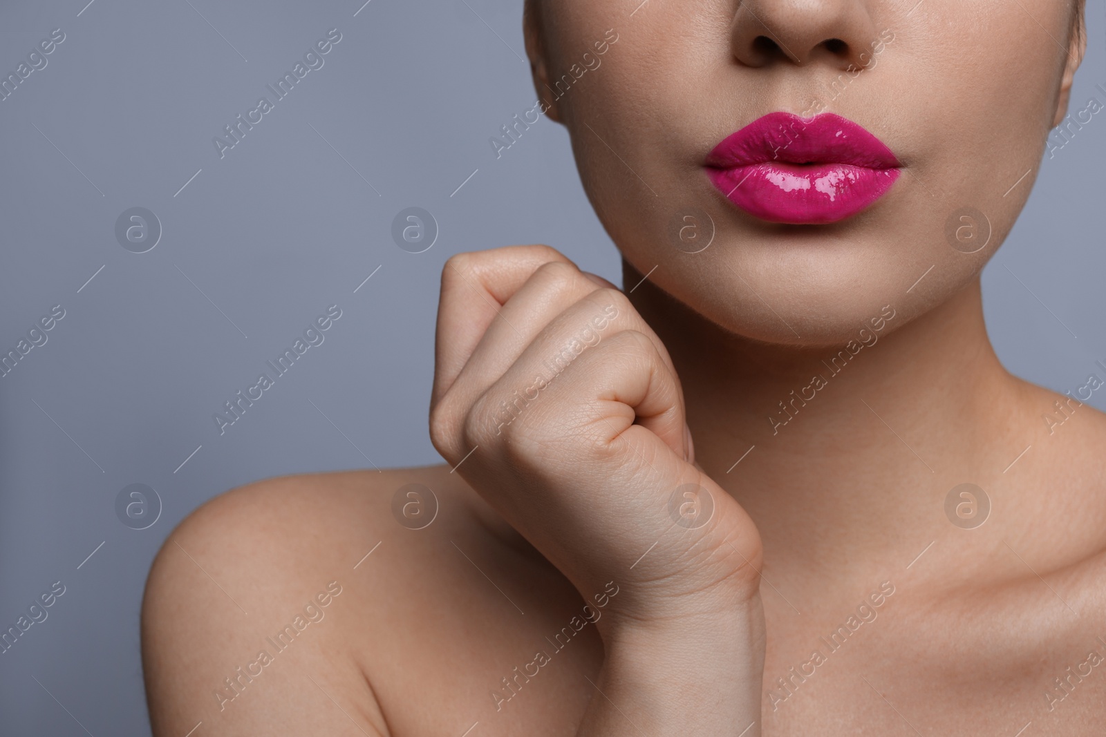 Photo of Closeup view of woman with beautiful full lips on grey background