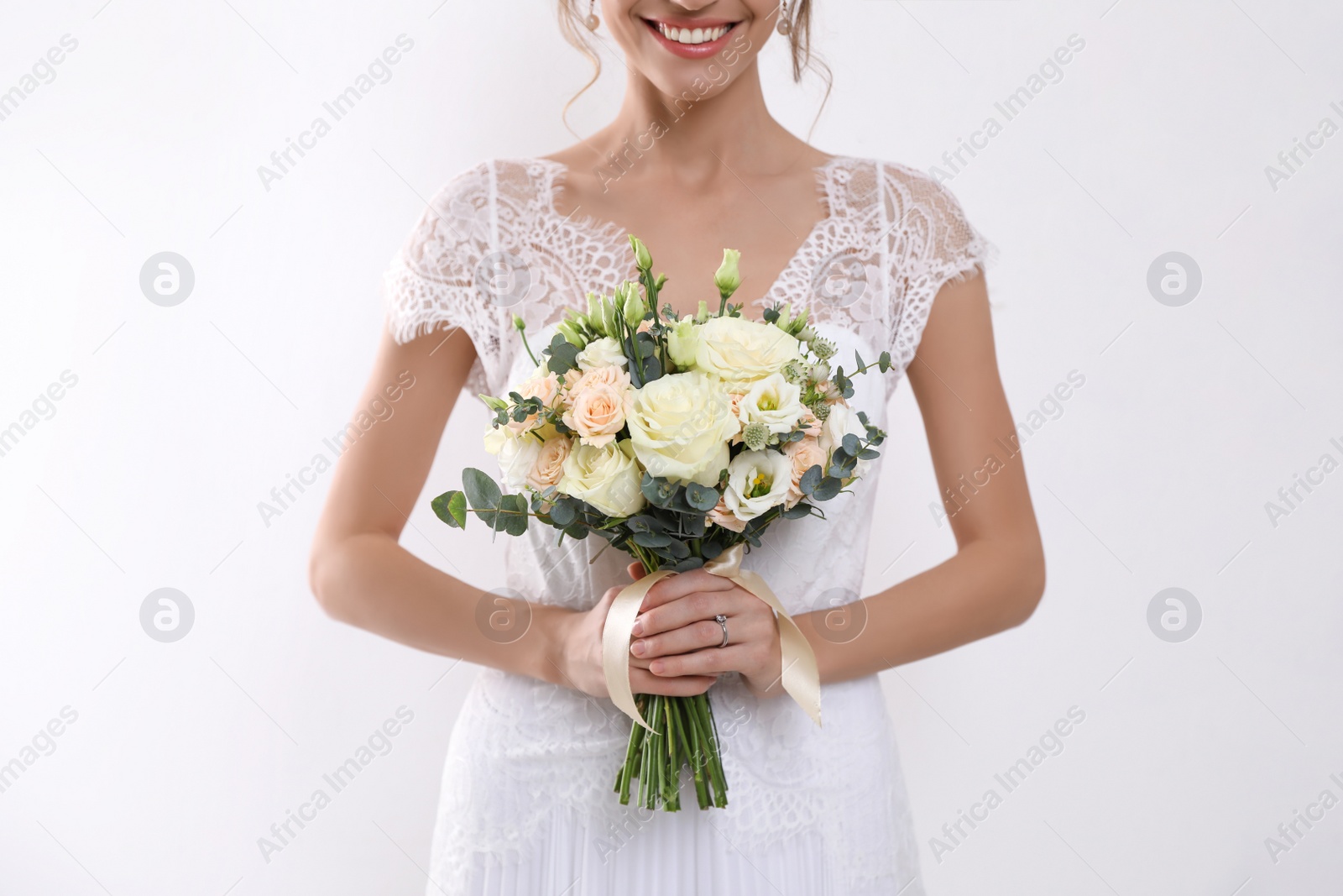 Photo of Young bride with beautiful wedding bouquet on white background, closeup