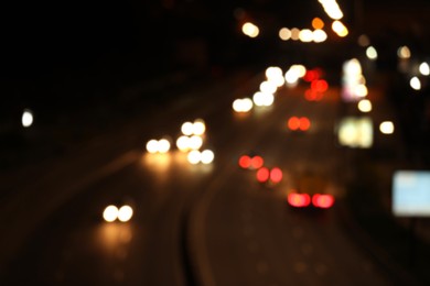 Photo of Blurred view of road with cars, bokeh effect. Night life