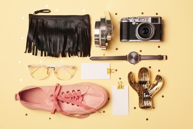 Flat lay composition with camera and stylish accessories on color background