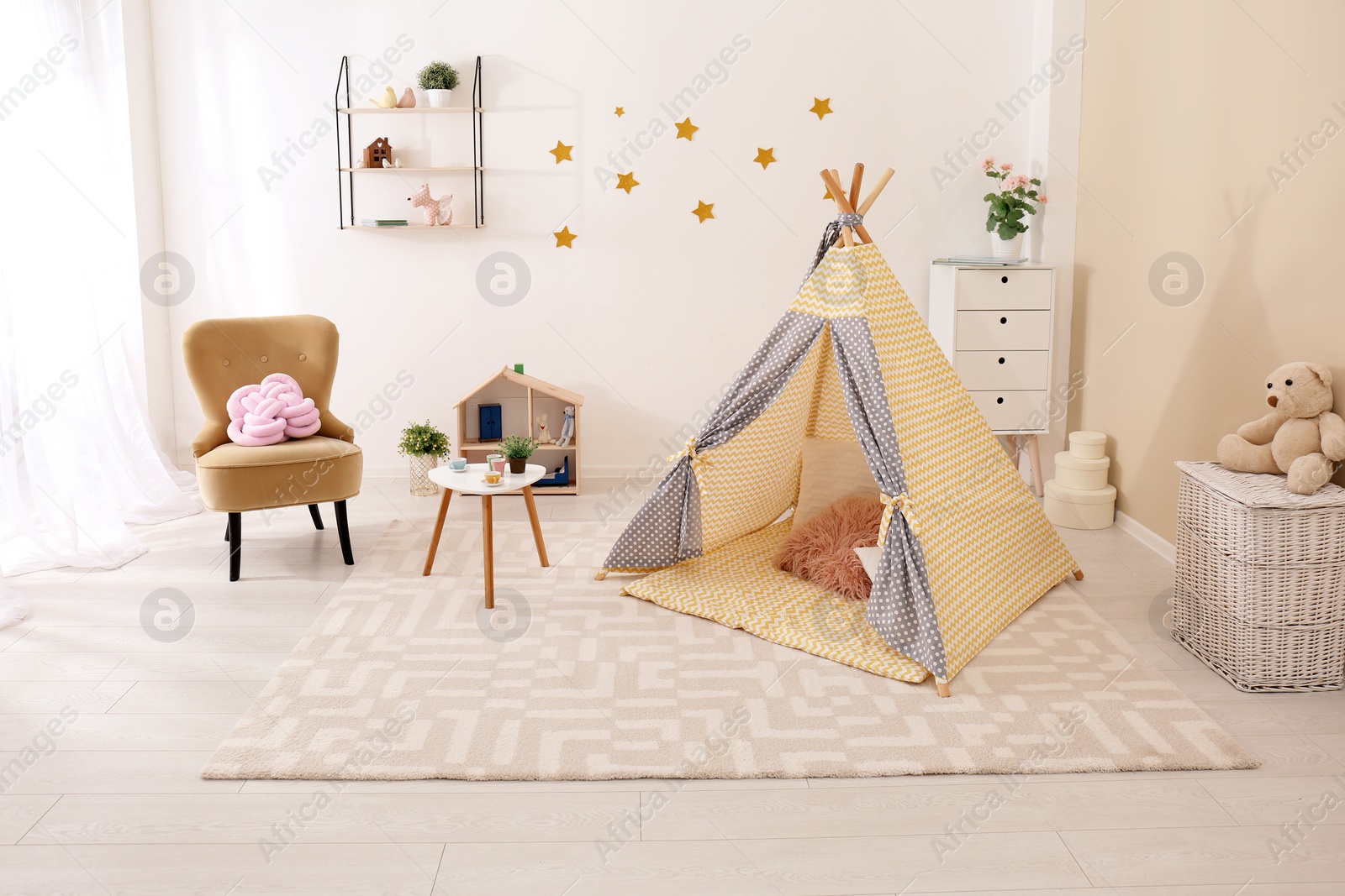 Photo of Cozy kids room interior with play tent and toys