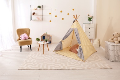 Cozy kids room interior with play tent and toys