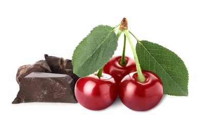 Fresh cherries and pieces of dark chocolate isolated on white