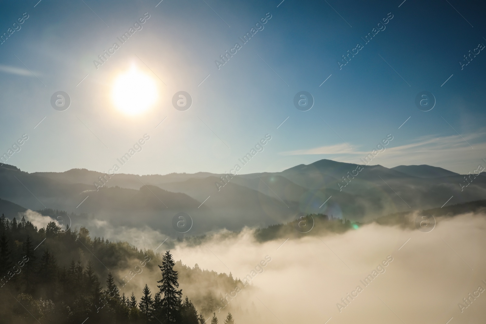 Photo of Beautiful view of mountains covered with fog at sunrise