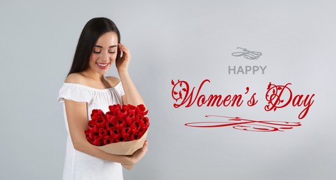 Happy Women's Day, Charming lady holding bouquet of beautiful flowers on grey background