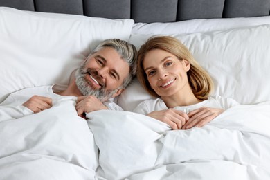 Photo of Lovely mature couple in bed at home