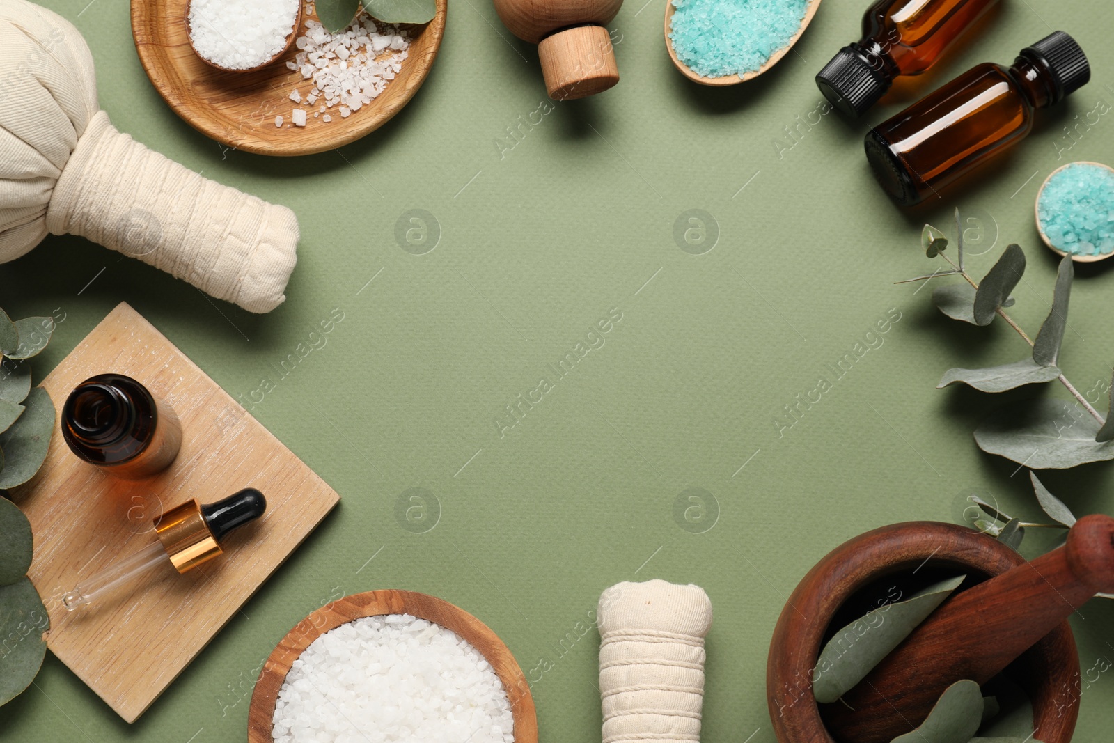 Photo of Different aromatherapy products and eucalyptus leaves on olive background, flat lay. Space for text