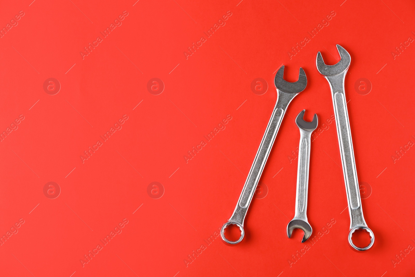 Photo of New wrenches on color background, top view with space for text. Plumber tools