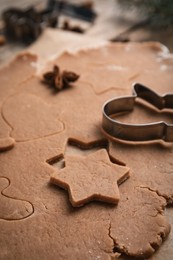 Photo of Making Christmas cookies. Raw dough and cutter on table, closeup