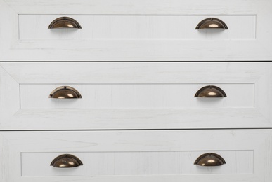 Photo of Modern chest of drawers, closeup. Furniture for wardrobe room
