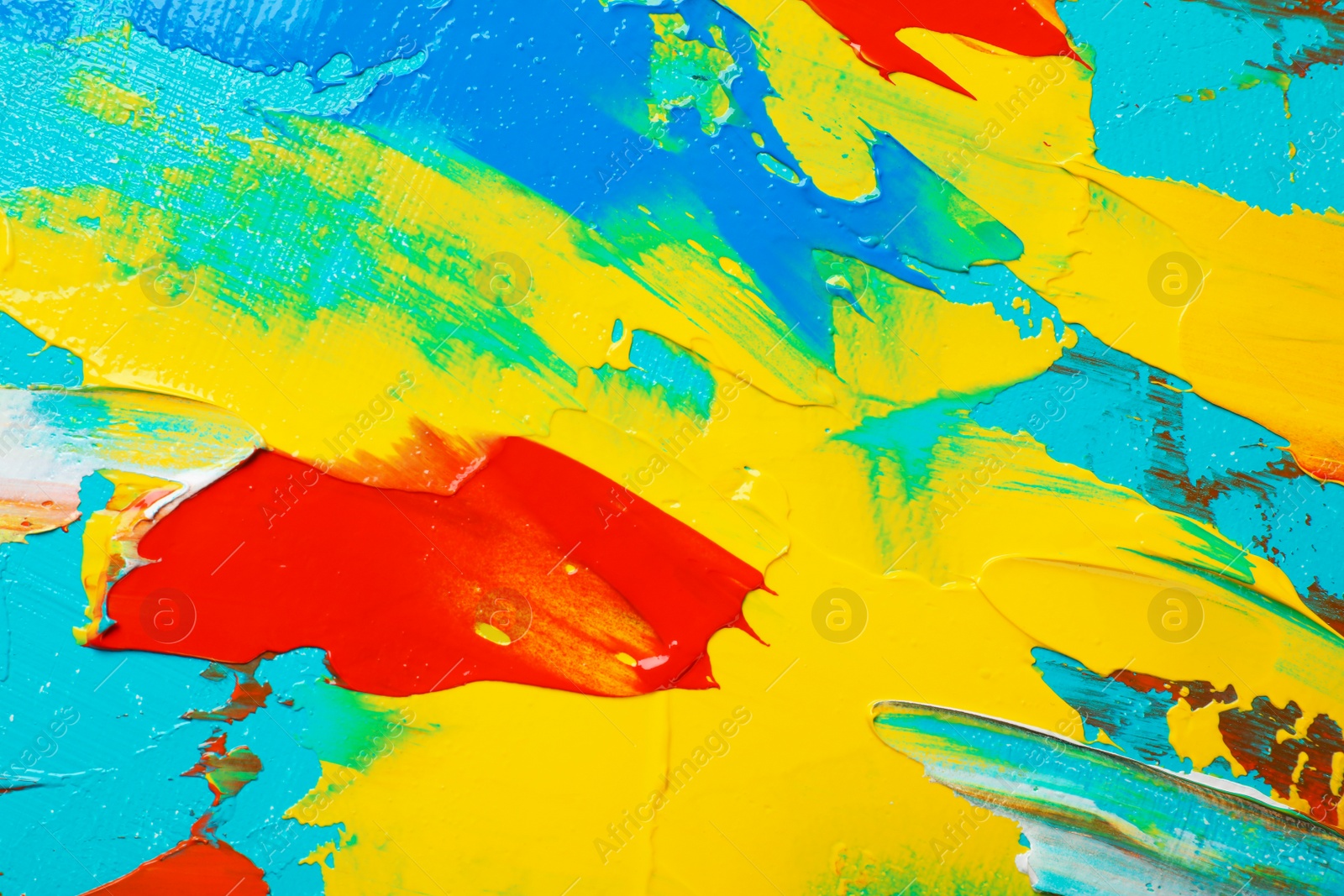 Photo of Closeup view of artist's palette with mixed bright paints as background