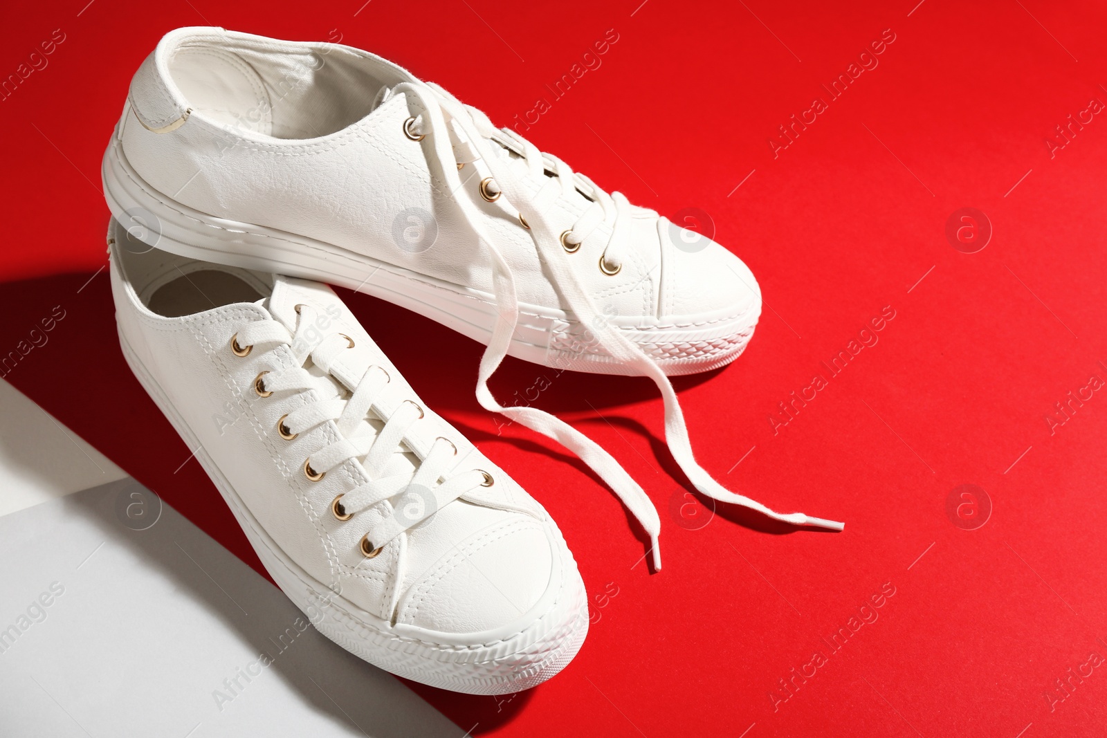 Photo of Pair of stylish sneakers on color background, space for text