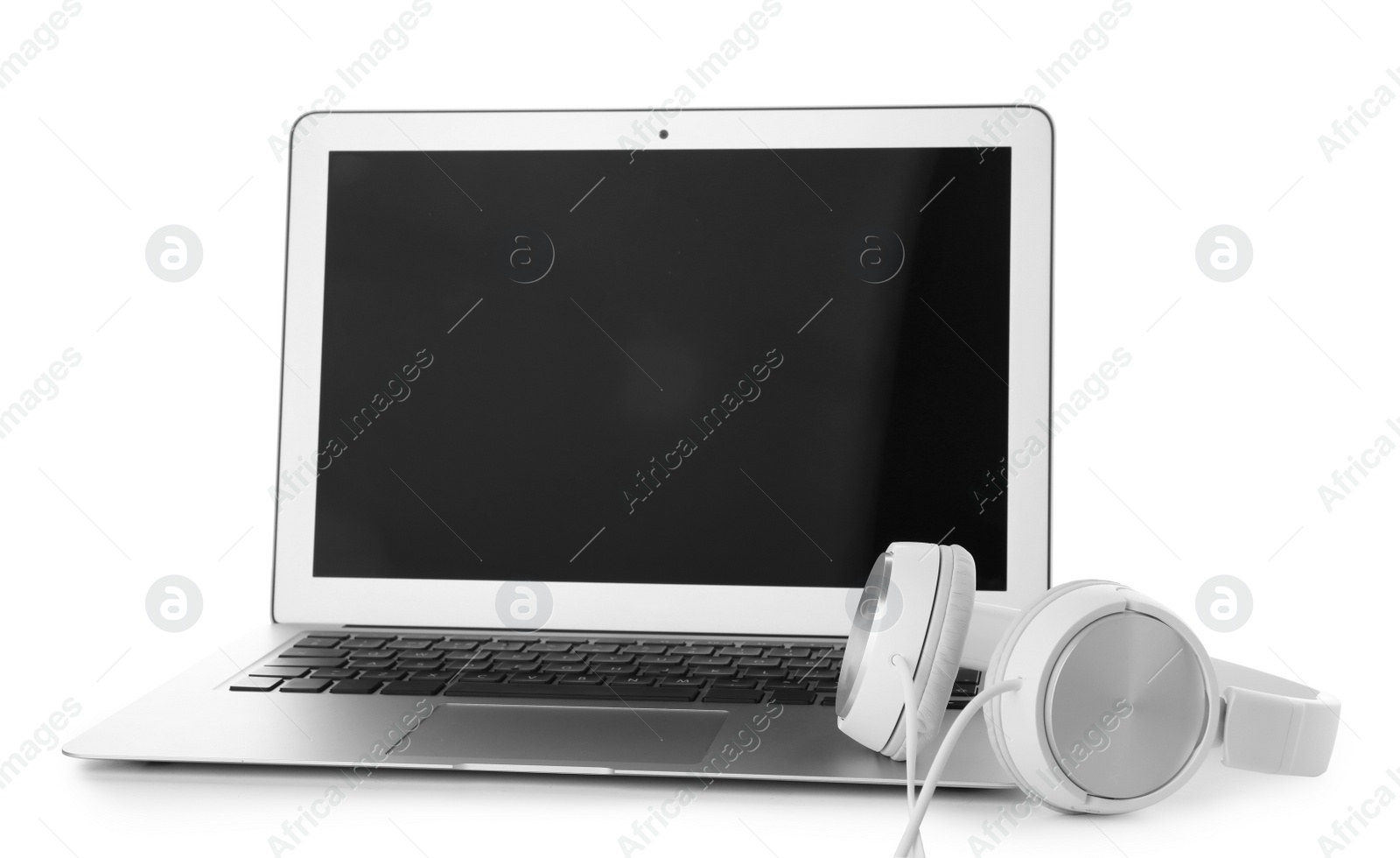 Photo of Laptop with blank screen and headphones on white background